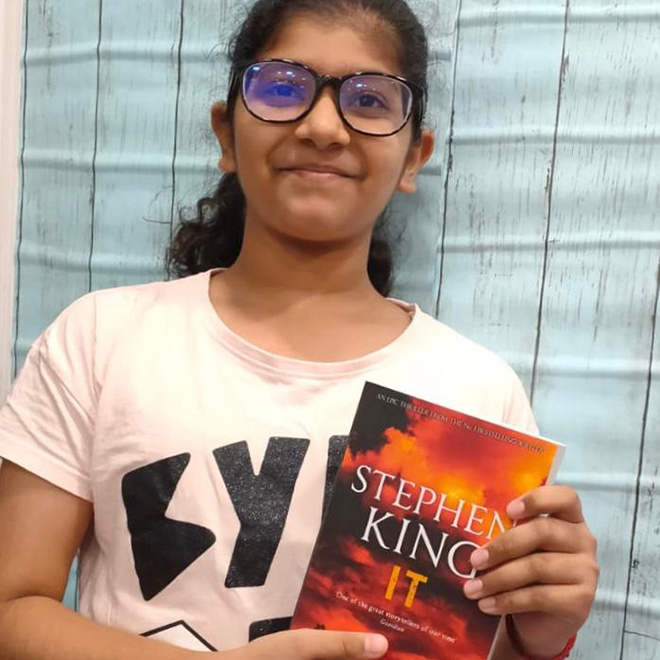 Writers Studio student holding a book