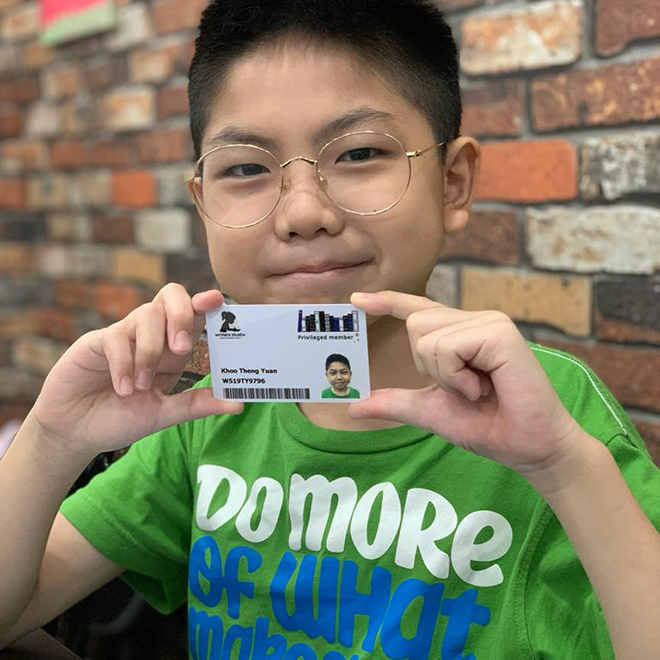 Writers Studio student holding an ID card