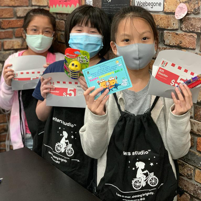 Writers Studio students holding gift vouchers