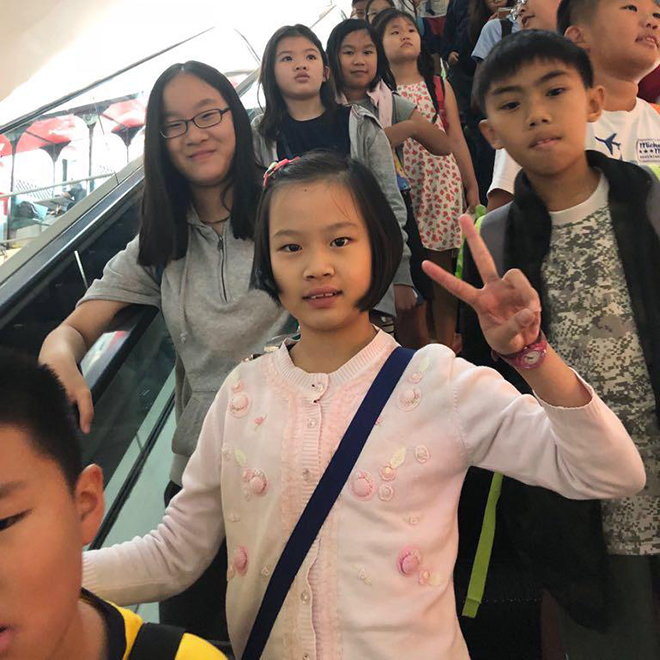 Writers Studio students on an escalator