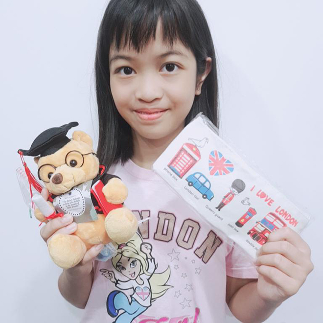 Writers Studio student holding a push toy and stickers