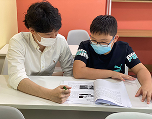 A student and teacher studying together in a classroom