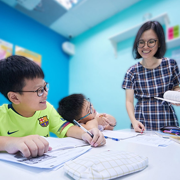 Teacher Stephanie teaching two boys